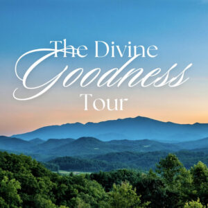 The Divine Goodness Tour above trees and blue mountains